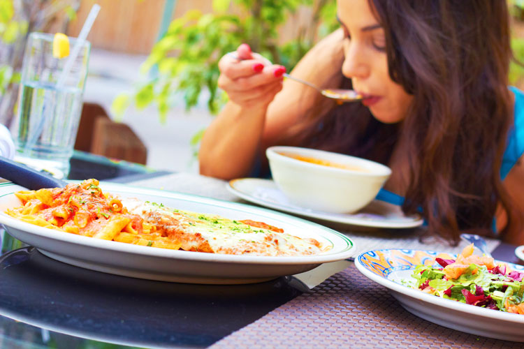 Young woman comfortably eating meal