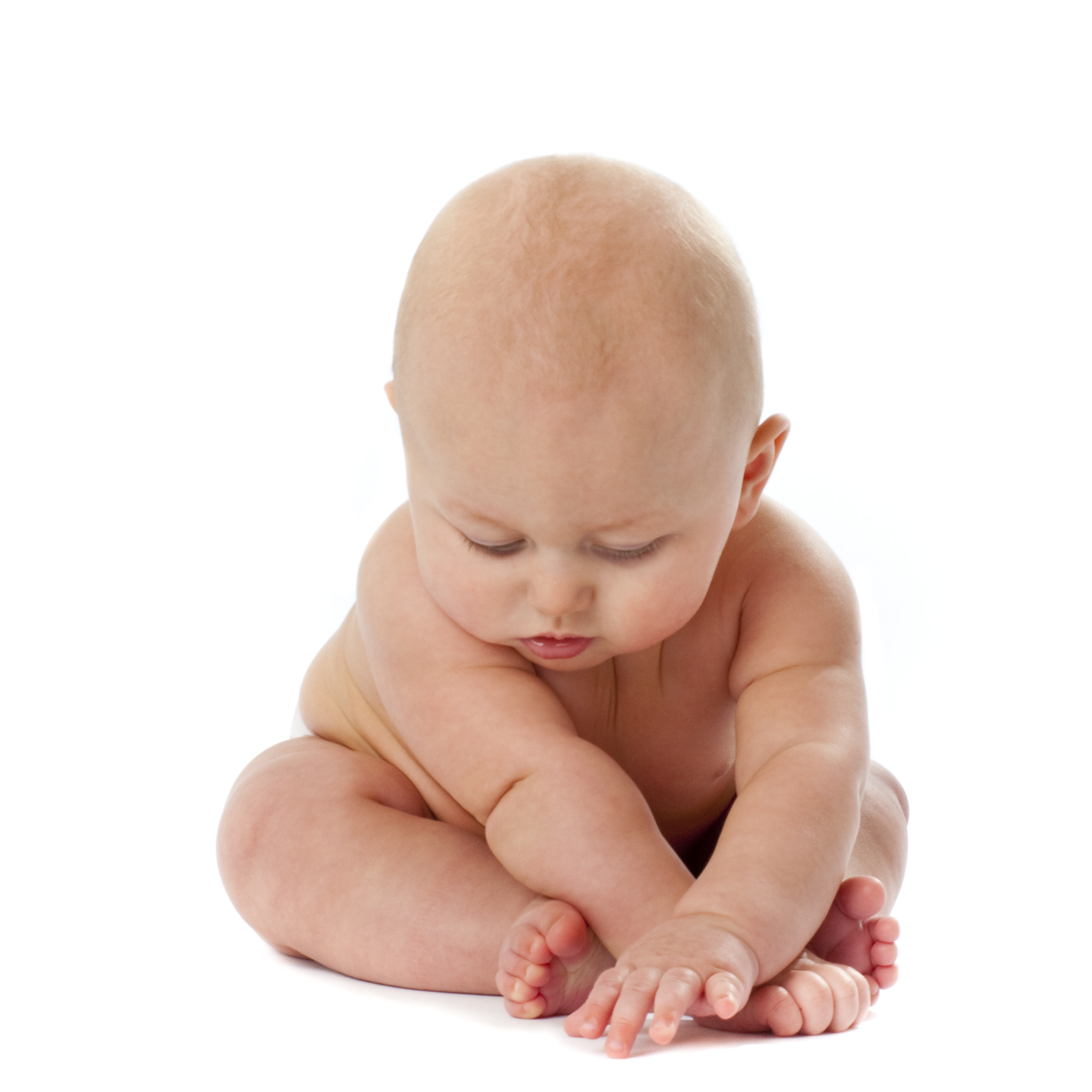 Chubby naked baby braced on legs and arms and leaning forward
