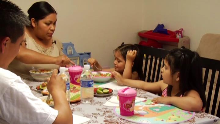 Toddler and preschool girls at pleasant family meal