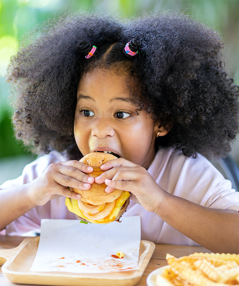 Girl Eating Hamburger